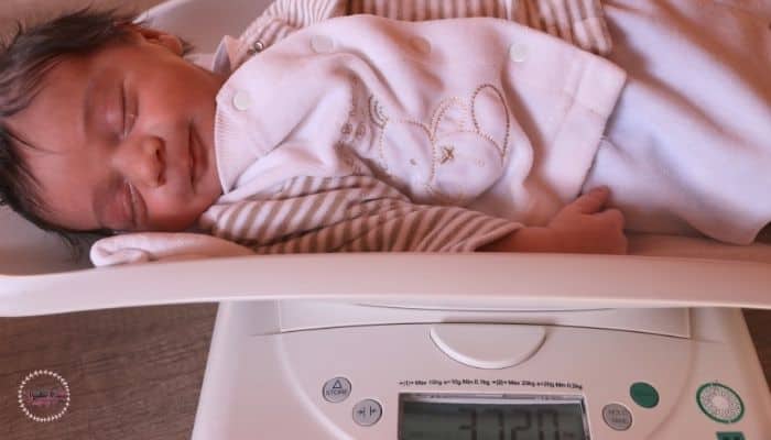 newborn on a weight machine 
