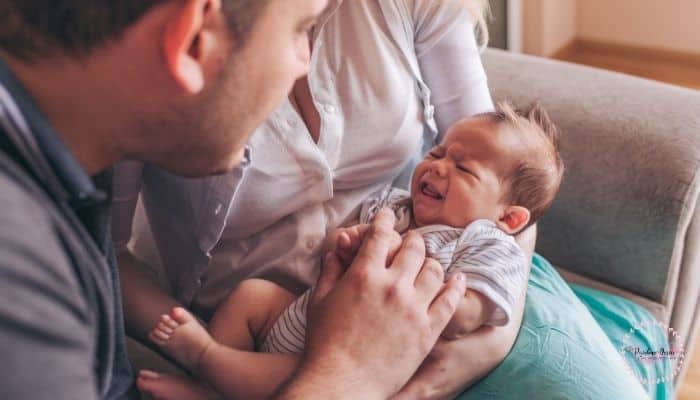 Mom and dad trying to soothe a crying baby